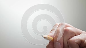 The artist drawing a flat line with a black pencil. Artists hands drawing wooden pencil writes line. Businessman makes a