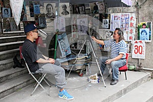 Artist drawing a portrait on Gulangyu Island in China