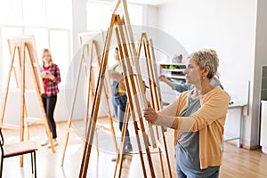 Artist with easel and pencil drawing at art school