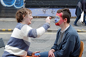 Artist Face Painter at Work in City Street
