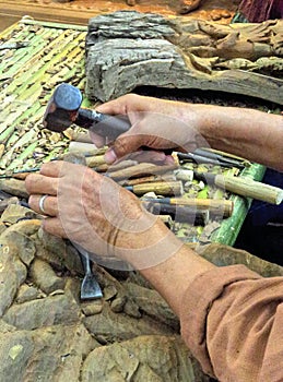 Artist hand busy with carving