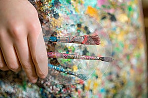 Artist hand holding paintbrush