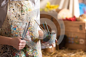 Artist hand holding paintbrush