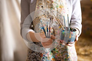 Artist hand holding paintbrush