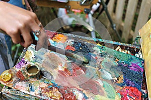 Artist hand paintbrush and palette