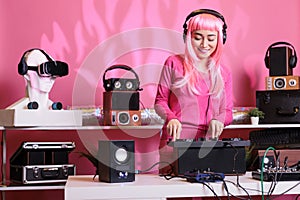 Artist with headphones playing electronic song at professional turntables