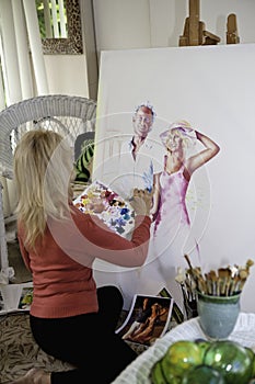 Artist in her fifties painting