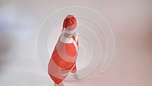 An artist in an inflatable Santa costume greets the viewer.