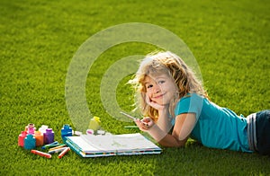 Artist kids. Child boy painting with paints color and brush in park outdoor. Kids early arts and crafts education.