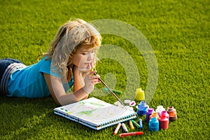 Artist kids. Schooler kids drawing in summer park, painting art. Little painter draw pictures outdoor.