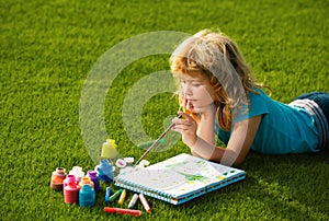 Artist kids. Schooler kids drawing in summer park, painting art. Little painter draw pictures outdoor.