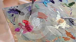 Artist mixes paint on the palette, Art brush mixed paint on the palette, artist brush mix color oil painting on palette