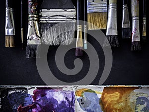 Artist paint brushes on dark background