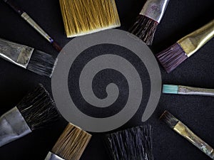 Artist paint brushes on dark background