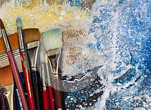 Artist Paint Brushes on a Painting