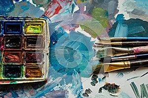Artist paint brushes and watercolor paintbox photo