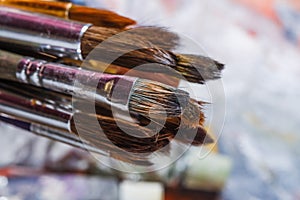 Artist paint brushes on wooden background