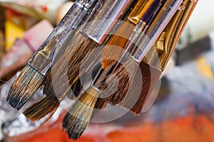 Artist paint brushes on wooden background