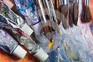 Artist paint brushes on wooden background
