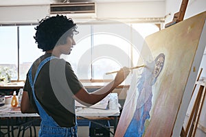 Artist painting on canvas in studio, creative workshop with oil color paint and young Indian woman with inspiration