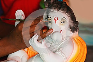 Artist painting Ganesha Idol. Pune Maharashtra India.