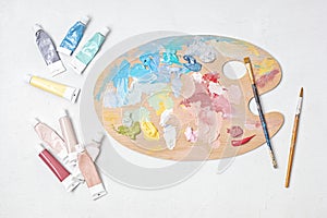 Artist painting palette with brushes. Artistic craft hobby background