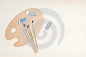 Artist painting palette with brushes. Craft hobby background