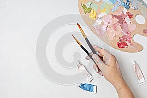 Artist painting palette with brushes. Craft hobby background