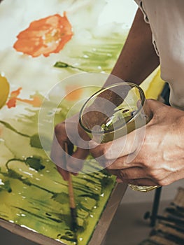 Artist painting picture on canvas with watercolours photo