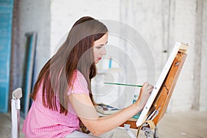 Artist painting picture on canvas whith watercolours photo