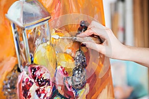 artist paints a picture of oil paint with palette-knife