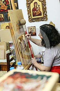 Artist paiting icons in icon painting studio in Kalabaka, Greece