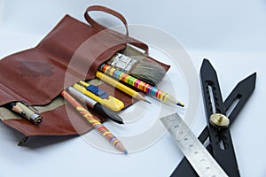 Artist pencil box or canvas of brown leather with drawing tools