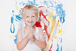 Artist preschool boy painting brush watercolors on a easel. School. Education. Creativity