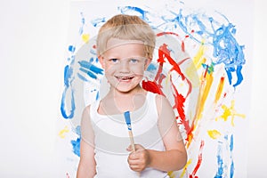 Artist preschool boy painting brush watercolors on a easel. School. Education. Creativity