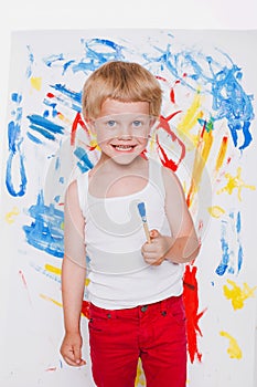 Artist preschool boy painting brush watercolors on a easel. School. Education. Creativity. Studio portrait over white background