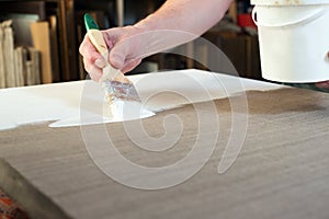 An artist priming canvas