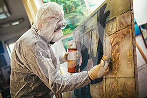 The artist restores the painting