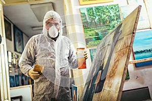 The artist restores the painting