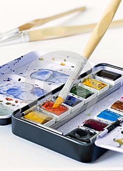 An artist`s metal compact travel paint tin