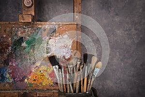 Artist`s palette, brushes, easel