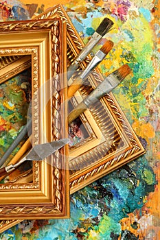 Artist's palette, paintbrushes and frames