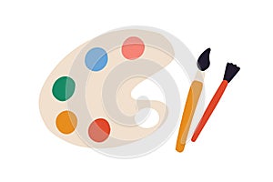 Artist's palette with paints of different colors and brushes or paintbrushes. Top view of painter's tools isolated on