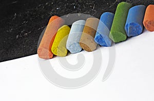 artistÃÂ´s pastels, detail macro shot with low DOF (depth of field), on contrast black and white papers arranged diagonally photo