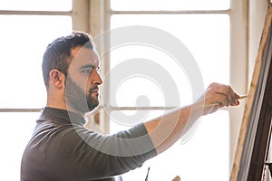 Artist/teacher holding a brush and painting - silhouette