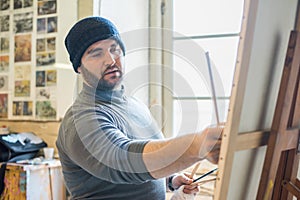 Artist/teacher painting an artwork - close up view