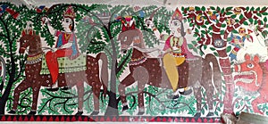 Artist trying to express the people horse riding through forest with the help of mithila art in madhubani India photo