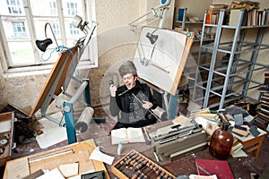 Artist in untidy studio