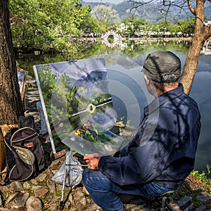 Artist at work, Chinese landscape painter