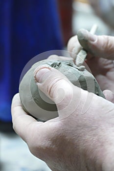 Artist working on small papier mache statue